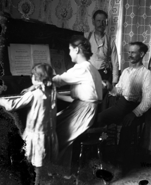 Family gathered around a piano