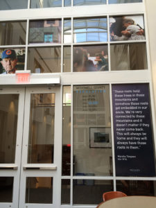 Images from the documentary Hollow adorn a wall in the Downtown Campus Library Atrium, photo by Alyssa Wright.