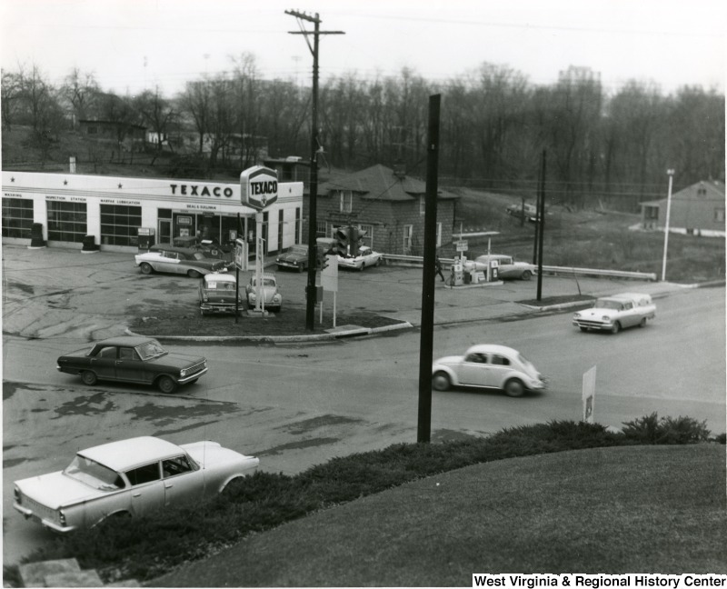 Texaco and vintage cars at the intersection of University Ave. and Patteson Dr. in Morgantown, ca. 1960s-1970s