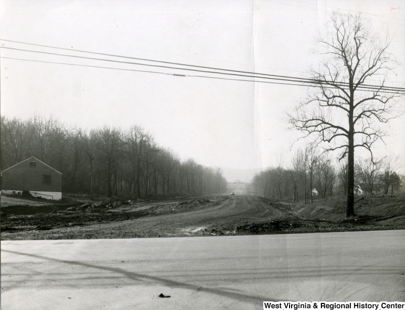 Dirt road (soon-to-be access road Patteson Drive) connected to paved road