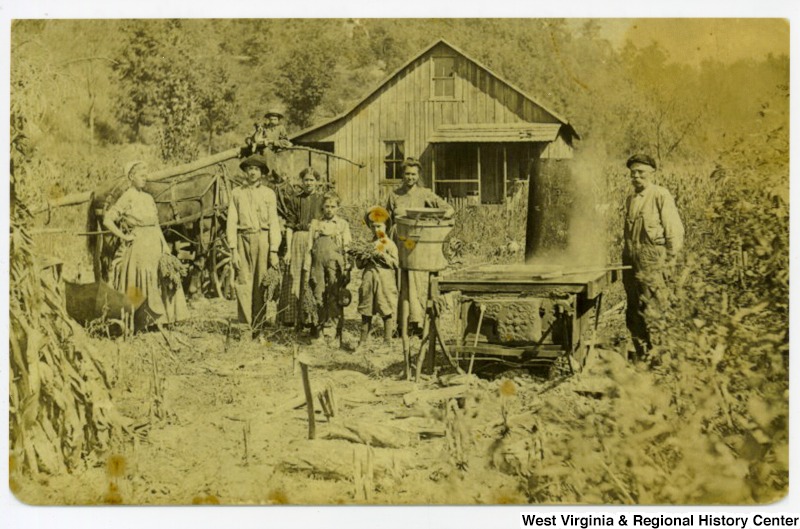 family standing outside house making molasses