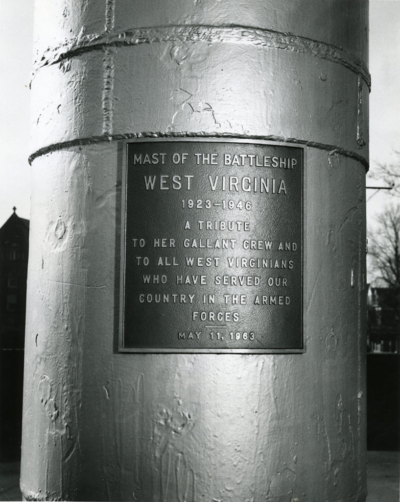 Plaque on the mast of the USS West Virginia which says "A tribute to her gallant crew and to all West Virginians who have served our country in the armed forces."