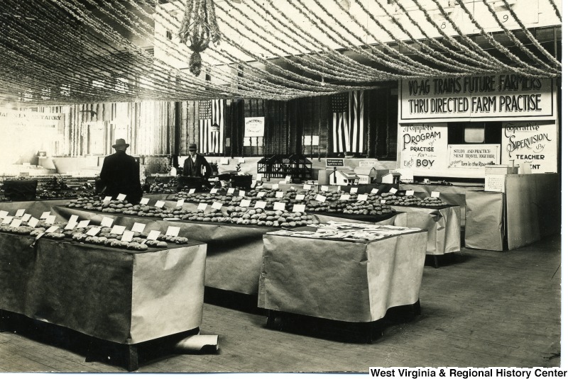 Farmers Week Exhibit with signage and tables full of produce