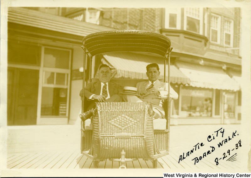 Joe Ozanic (on right) and another man sitting in a cart at the Atlantic City Boardwalk