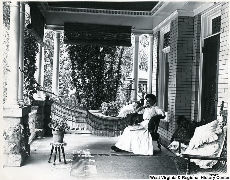 Photo of a woman on a large and well-furnished porch