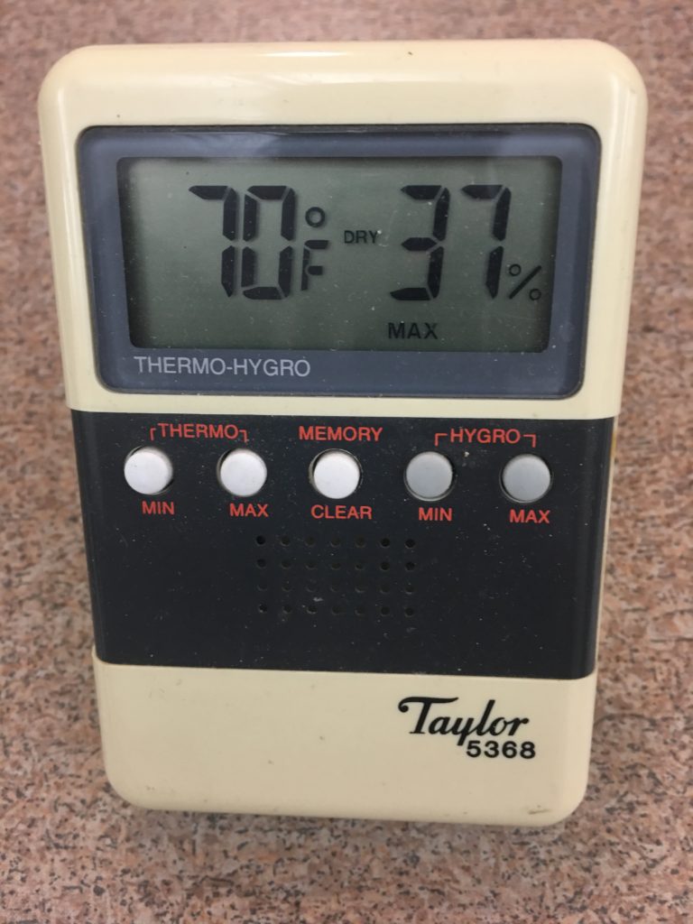 Hygrometer/thermometer showing 70 degrees and 37 percent humidity