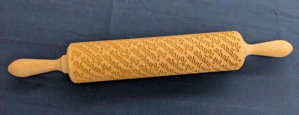 Laser cut rolling pin that says "Made by Lucinda Ebersole"