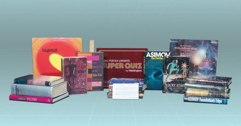 Assortment of Asimov-related books and a game