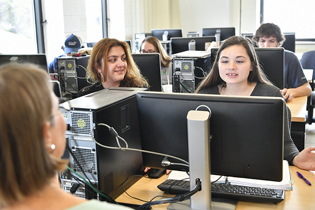 professor and students working in computer lab