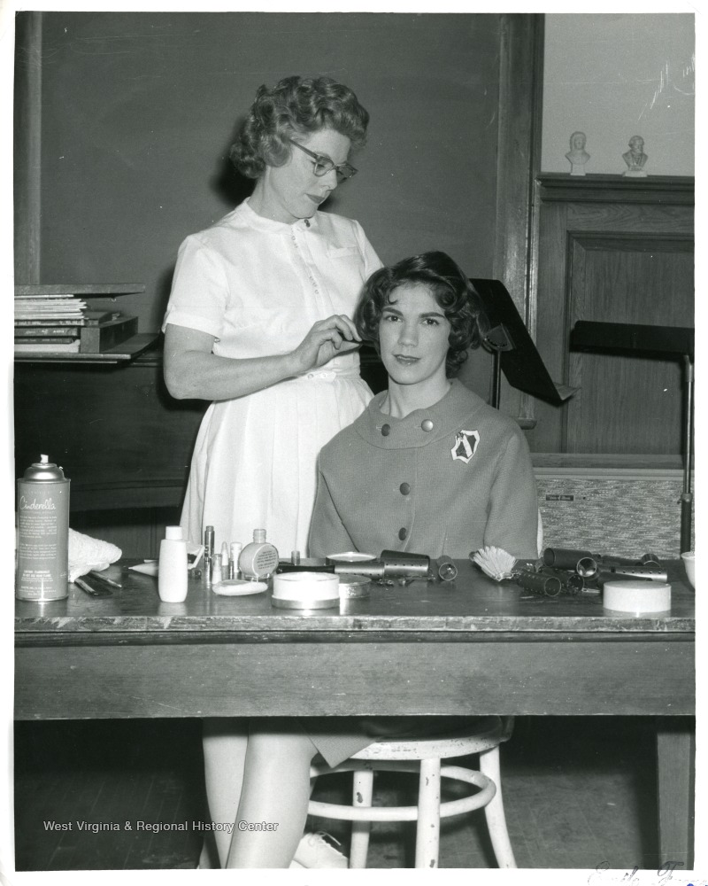 Hairdresser combing woman's hair