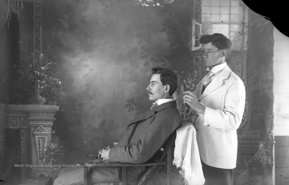 Barber brushing man's hair