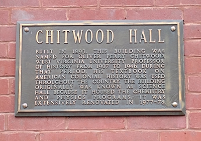 Plaque on bricks, titled "Chitwood Hall" with historical information about the hall and the man it was named for.