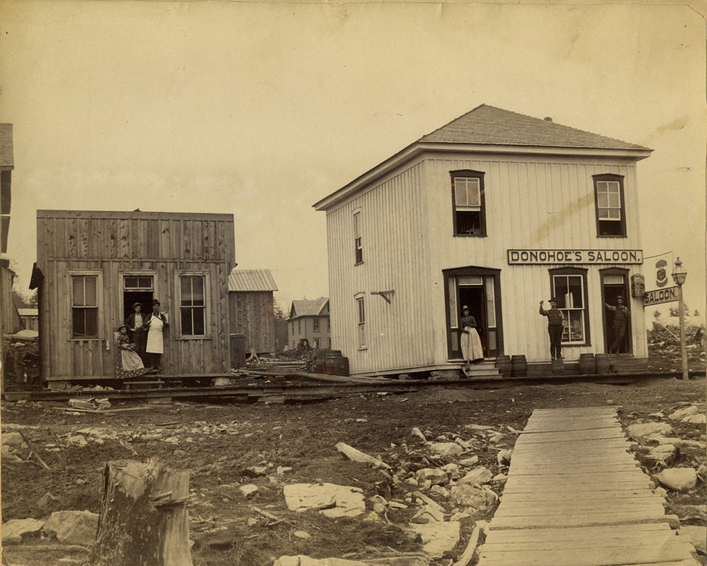 Two men standing in front of a saloon