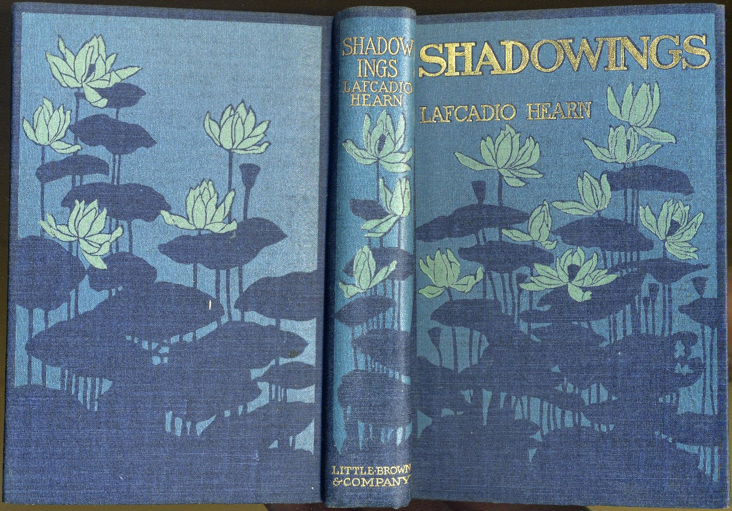 Front and back covers and spine of Shadowings book, with lotus flower motif