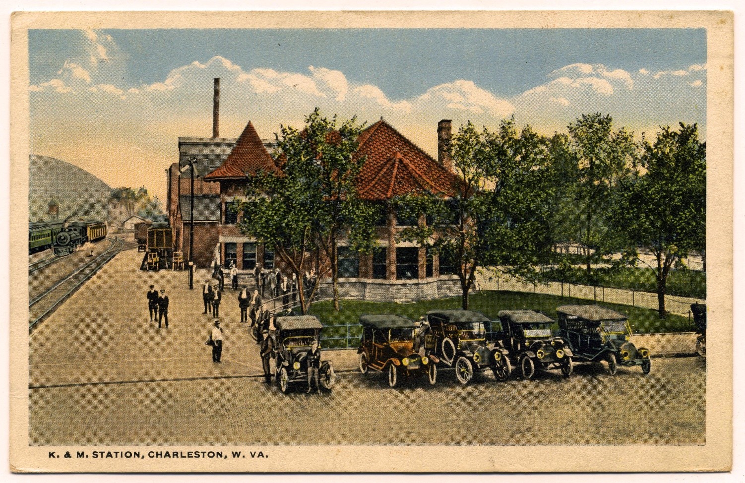 Train depot with classic cars parked out front