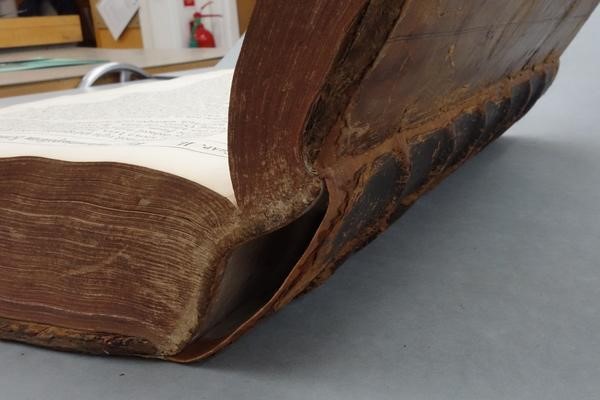 Close up view of the spine of an open hardcover book