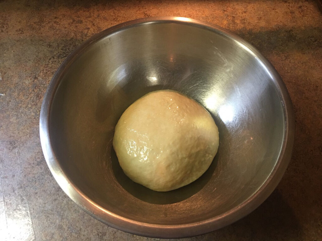 Ball of dough in metal bowl