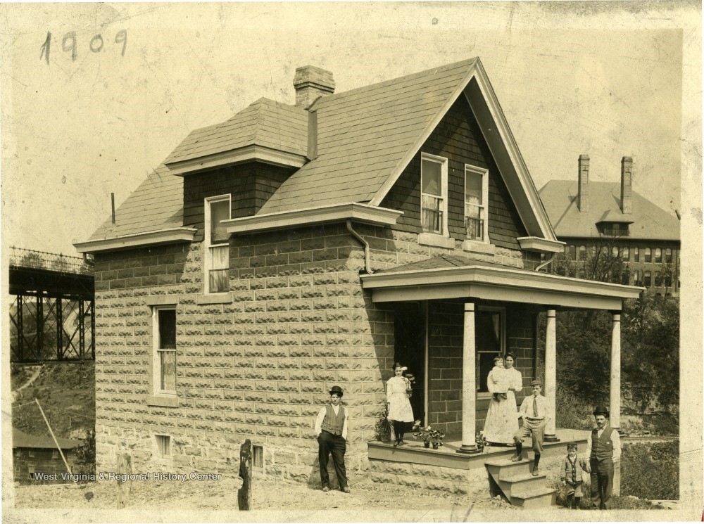 House with family gathered on and around the front porch