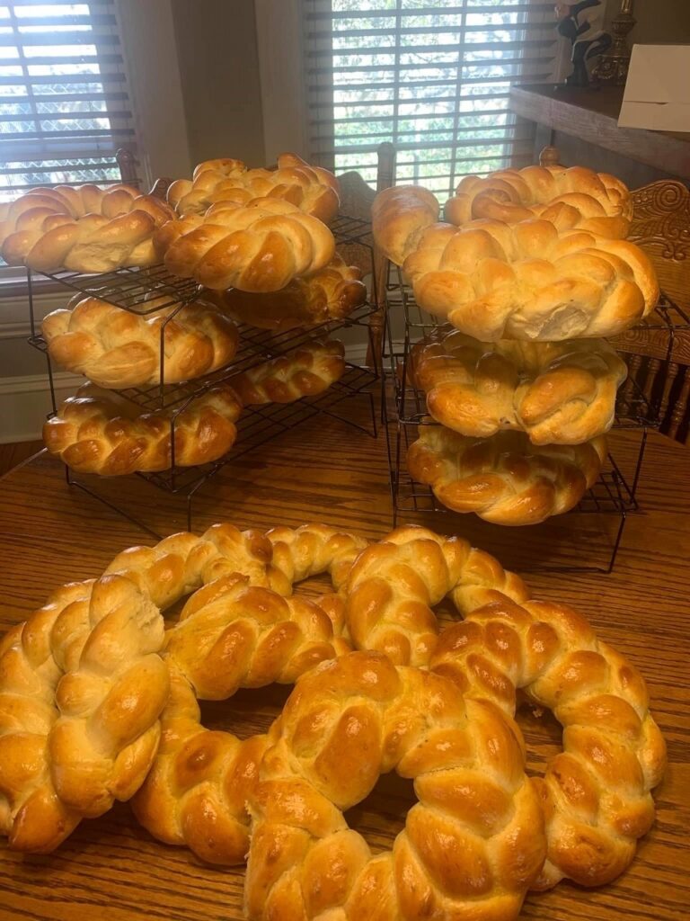 A dozen or so round loaves of braided Easter bread