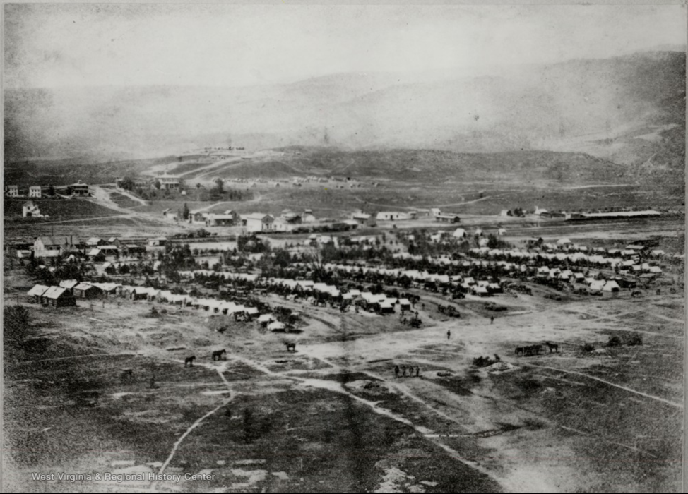 Tents in rows with town in background