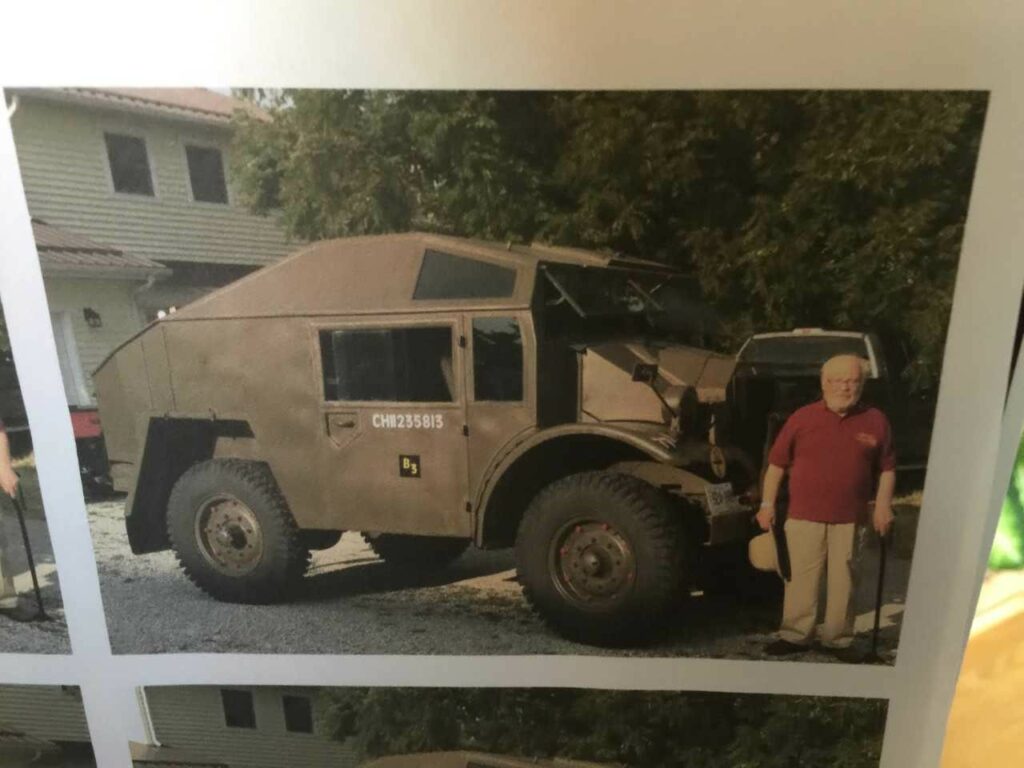 Dr. Emory Kemp standing next to a British Army artillery tractor