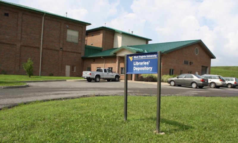 Exterior view of brick building with the sign "Libraries' Depository"