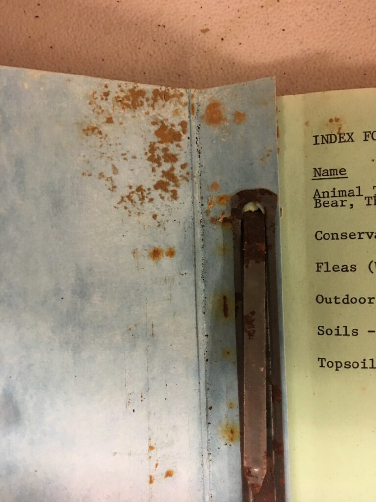 rusty metal binder and marks on paper