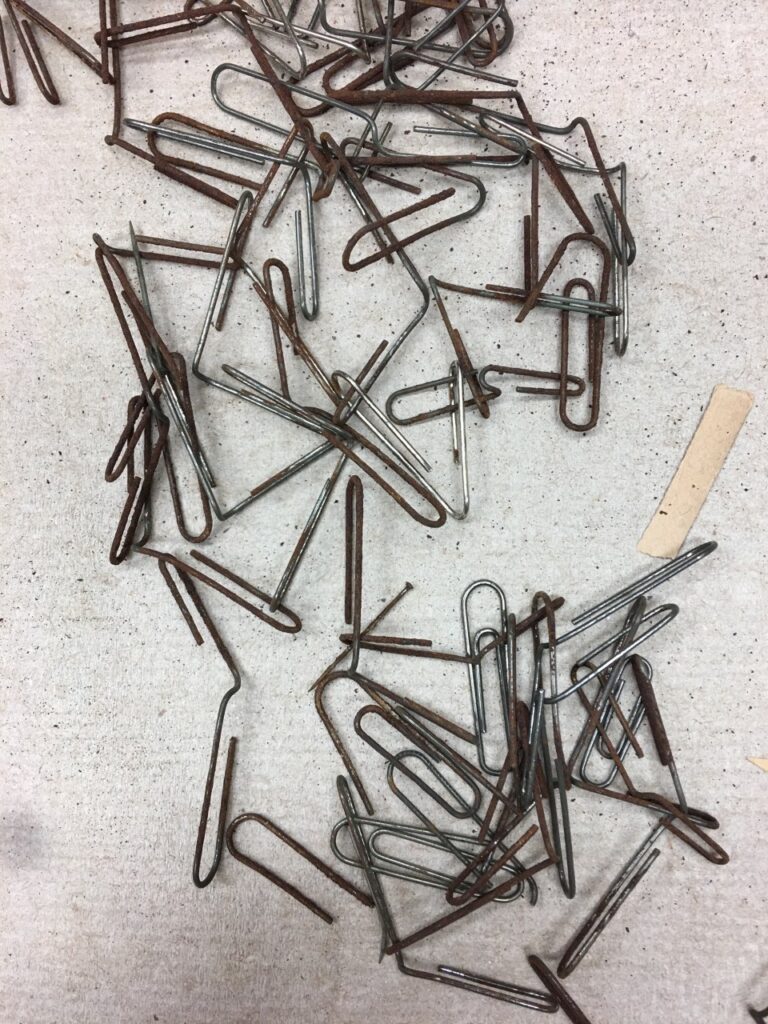 Rusted paperclips, all partly open