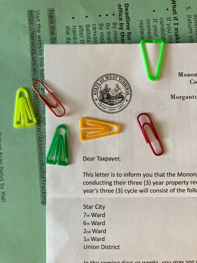 Plastiklips and plastic coated paperclips on top of a "Dear Taxpayer" letter