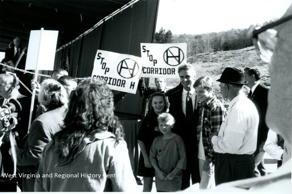 Group of people posing with "Stop Corridor H" signs