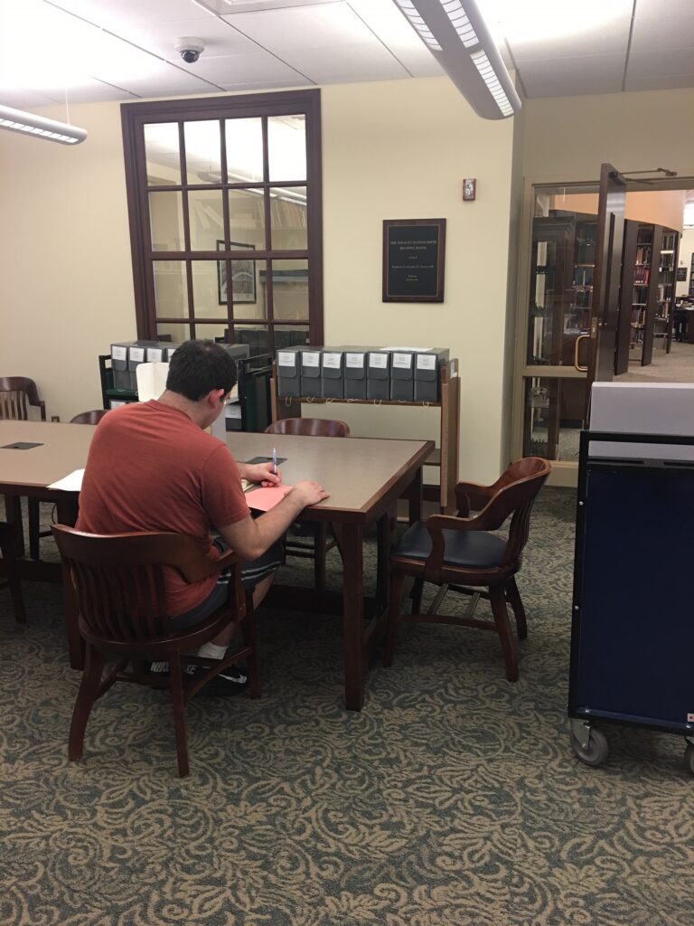 Man studying document on table