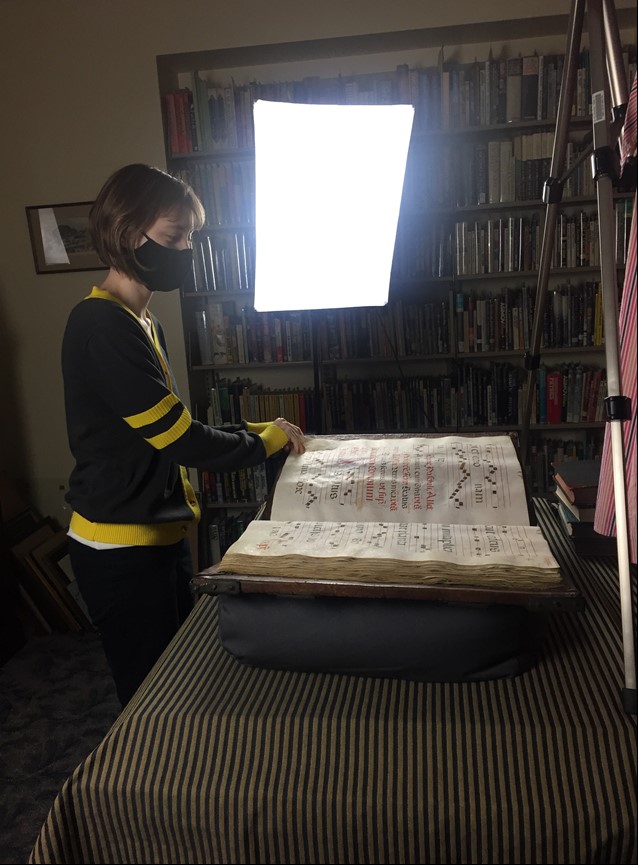 Woman turning the pages of a large book