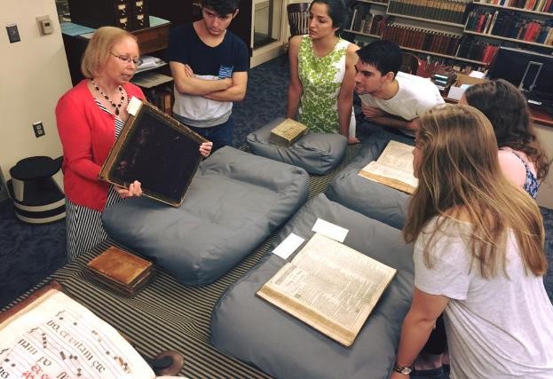 Instructor showing a large book to students