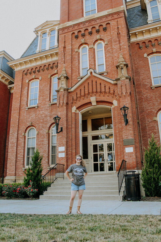 Woman standing in front of brick building