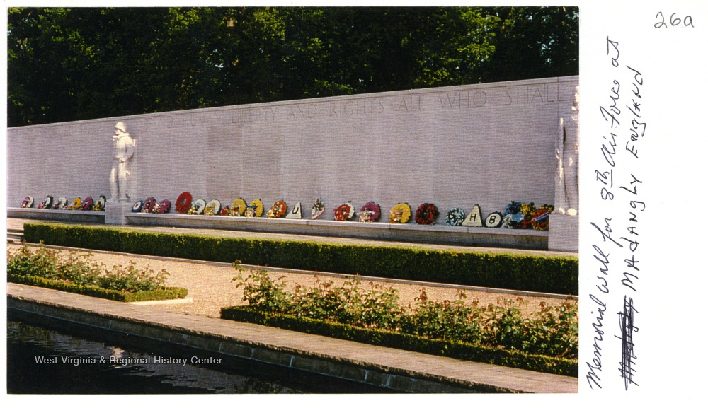 Memorial wall with flower wreaths along the bottom