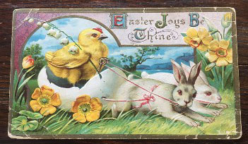 Easter postcard showing rabbits pulling an egg in which rides a chick