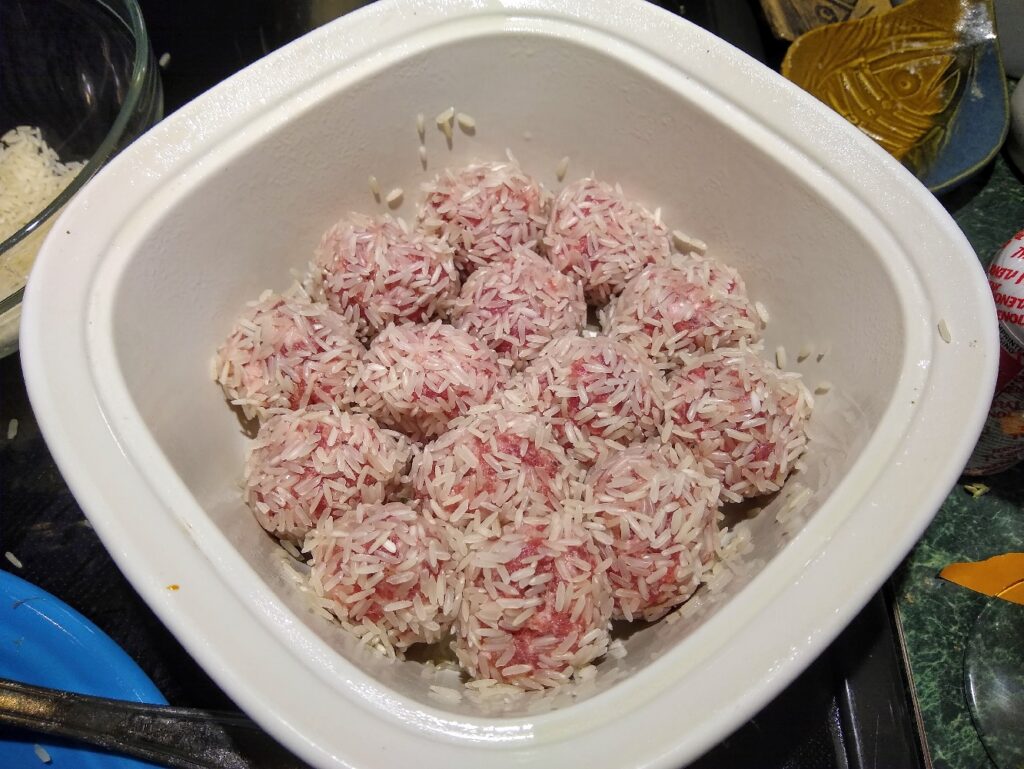 Rice covered porcupine sausage balls in a bowl