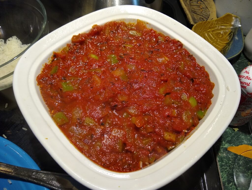 Porcupine sausage balls covered with the tomato and pepper mixture