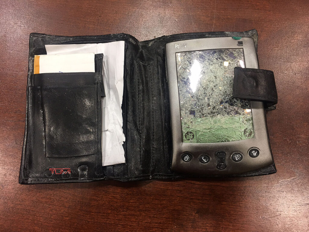 A Palm Pilot in a case; it has been crushed