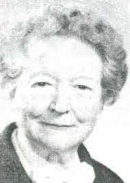 Gertrude Humphreys, an older white woman smiling with short hair and a blouse and jacket.