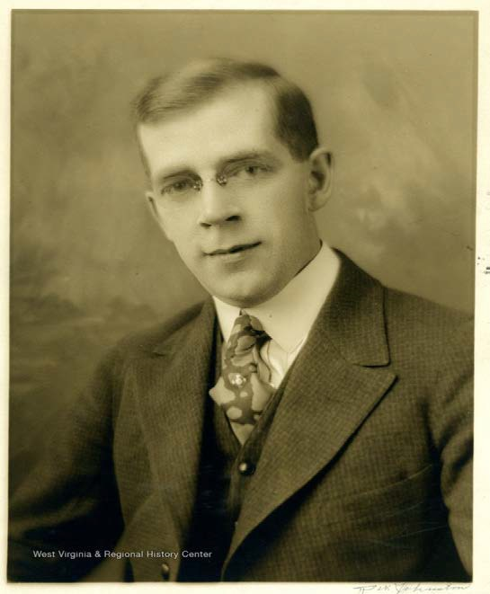 A photograph of Arthur Dayton, an adult white man with light colored hair, glasses, and wearing a suit and tie. 